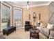 Cozy living room with neutral tones, a comfortable sofa, and natural light streaming through large windows at 124 Shelton Dr, Mcdonough, GA 30252