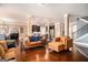 Spacious open-concept living room features hardwood floors, large windows, and comfortable seating at 124 Shelton Dr, Mcdonough, GA 30252