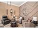 Cozy living room featuring a large decorative clock, comfortable seating, and modern accents at 124 Shelton Dr, Mcdonough, GA 30252