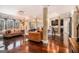 Open-concept living room with hardwood floors, large windows, and comfortable seating at 124 Shelton Dr, Mcdonough, GA 30252