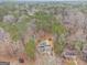 A lovely aerial view of a home with a backyard pool surrounded by lush, mature trees at 620 Bell Se Rd, Conyers, GA 30094