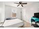 Simple bedroom with neutral walls, carpet, ceiling fan and a window with natural light at 620 Bell Se Rd, Conyers, GA 30094