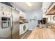 Functional kitchen with stainless steel refrigerator, white cabinets, wood countertops, and modern appliances at 620 Bell Se Rd, Conyers, GA 30094