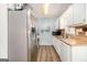 Functional kitchen with stainless steel refrigerator, white cabinets, wood countertops, and modern appliances at 620 Bell Se Rd, Conyers, GA 30094