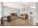 Cozy living room with a brick fireplace, ceiling fan, and lots of space for furniture at 620 Bell Se Rd, Conyers, GA 30094