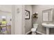 Cozy half bathroom with a pedestal sink, decorative shelves, and neutral tones that enhance the space at 615 Edgar St # 13, Hampton, GA 30228