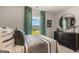 Bright bedroom with a green patterned curtains overlooking the backyard at 615 Edgar St # 13, Hampton, GA 30228