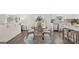 A dining area featuring a round table set on a stylish rug, nestled between the living area and kitchen at 615 Edgar St # 13, Hampton, GA 30228