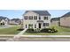 Charming two-story home with a combination of brick and stone exterior and manicured landscaping at 615 Edgar St # 13, Hampton, GA 30228