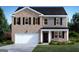 Two-story home with brick and gray shingle siding, complemented by a well-manicured green lawn at 615 Edgar St # 13, Hampton, GA 30228