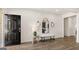 View of the home's foyer, featuring a dark front door, light walls, and a decorative mirror with accent furniture at 615 Edgar St # 13, Hampton, GA 30228