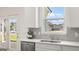 Bright kitchen sink and stainless steel dishwasher under a window with a beautiful outside view at 615 Edgar St # 13, Hampton, GA 30228