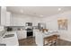 Modern kitchen featuring stainless steel appliances, sleek countertops, and a functional island with bar stools at 615 Edgar St # 13, Hampton, GA 30228