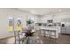 Bright, open concept kitchen with stainless steel appliances and adjacent dining area perfect for gatherings at 615 Edgar St # 13, Hampton, GA 30228