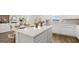 Bright and airy kitchen with white cabinets, stainless appliances, and an island counter for casual dining at 615 Edgar St # 13, Hampton, GA 30228