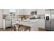 Beautiful kitchen with white cabinets, stainless steel appliances, and a center island with seating at 615 Edgar St # 13, Hampton, GA 30228