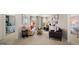 A living room is shown with neutral decor and comfortable seating at 615 Edgar St # 13, Hampton, GA 30228