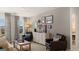 A living room is shown with neutral decor and comfortable seating at 615 Edgar St # 13, Hampton, GA 30228