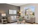 Cozy living room with comfortable seating, decorative artwork, and large windows overlooking the neighborhood at 615 Edgar St # 13, Hampton, GA 30228