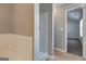 Bright bathroom features a bathtub with a tiled backsplash and neutral wall color at 6746 Lake Erie Ln, Fairburn, GA 30213