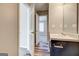 Modern bathroom with a dark vanity and wood-look floors at 6746 Lake Erie Ln, Fairburn, GA 30213