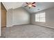 Spacious bedroom featuring high ceilings, neutral paint, carpeted floors, and a ceiling fan at 6746 Lake Erie Ln, Fairburn, GA 30213