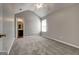 Neutral bedroom featuring vaulted ceiling, plush carpeting, and a window at 6746 Lake Erie Ln, Fairburn, GA 30213