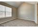 Bedroom features neutral walls, plush carpeting, a window, and natural light at 6746 Lake Erie Ln, Fairburn, GA 30213
