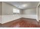 Elegant dining area with hardwood floors, wainscoting, and natural light, perfect for Gathering gatherings at 6746 Lake Erie Ln, Fairburn, GA 30213