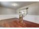 Elegant dining area with hardwood floors, wainscoting, and an open view into the modern kitchen at 6746 Lake Erie Ln, Fairburn, GA 30213