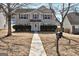 Charming two-story home featuring neutral siding, red shutters, and mature trees at 6746 Lake Erie Ln, Fairburn, GA 30213