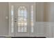 Elegant front door featuring decorative glass and white trim, adding curb appeal at 6746 Lake Erie Ln, Fairburn, GA 30213
