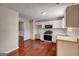 Bright kitchen features white cabinets, stainless steel appliances and hardwood floors at 6746 Lake Erie Ln, Fairburn, GA 30213