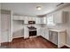 Well-lit kitchen featuring white cabinetry, stainless steel appliances, and hardwood floors, a chef's delight at 6746 Lake Erie Ln, Fairburn, GA 30213