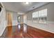 Hardwood floors and neutral walls in an open living area and access to other rooms at 6746 Lake Erie Ln, Fairburn, GA 30213