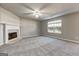 Comfortable living room with a fireplace and large window, providing ample natural light at 6746 Lake Erie Ln, Fairburn, GA 30213