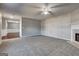 Spacious living room with plush carpeting, ceiling fan, and an inviting layout, ideal for comfortable living at 6746 Lake Erie Ln, Fairburn, GA 30213