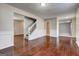 Hardwood floors, staircase and neutral walls create an open living area with easy access to other rooms at 6746 Lake Erie Ln, Fairburn, GA 30213