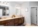 Bright bathroom features double vanity with granite countertop and a well-lit mirror at 165 Ruby Ln, Mcdonough, GA 30252