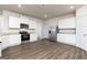 Modern kitchen featuring stainless steel appliances, white cabinets, and granite countertops at 1028 Claas Way, Locust Grove, GA 30248