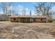 View of the backyard and exterior of the home, featuring a screened in back porch at 2864 S 100 Hwy, Bowdon, GA 30108