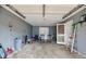 Cluttered garage featuring a ladder, chairs, and various stored items at 2864 S 100 Hwy, Bowdon, GA 30108