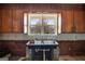 Cozy kitchen featuring stainless steel sink and view of the wooded exterior at 2864 S 100 Hwy, Bowdon, GA 30108