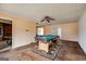 Large living room showing the billiard table with open view to the kitchen at 2864 S 100 Hwy, Bowdon, GA 30108