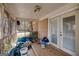 Enclosed back porch filled with discarded items, with a view of the backyard at 2864 S 100 Hwy, Bowdon, GA 30108