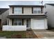 Charming two-story home with tan siding, brown shutters, a white picket fence, and an attached one-car garage at 419 Kara Ln, Mcdonough, GA 30253