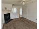 Comfortable living room with a cozy fireplace, neutral carpet, and access to the outdoors at 419 Kara Ln, Mcdonough, GA 30253