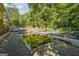 Backyard pool with a murky surface and concrete surround, enclosed by a chain-link fence at 6226 Lullwater Dr, Douglasville, GA 30135