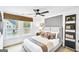 Sunlit bedroom featuring a modern gray headboard, neutral tones, and a large window at 5711 Tillman Way, Powder Springs, GA 30127