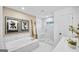 A luxurious bathroom with a soaking tub, glass-enclosed shower, and modern fixtures at 5711 Tillman Way, Powder Springs, GA 30127
